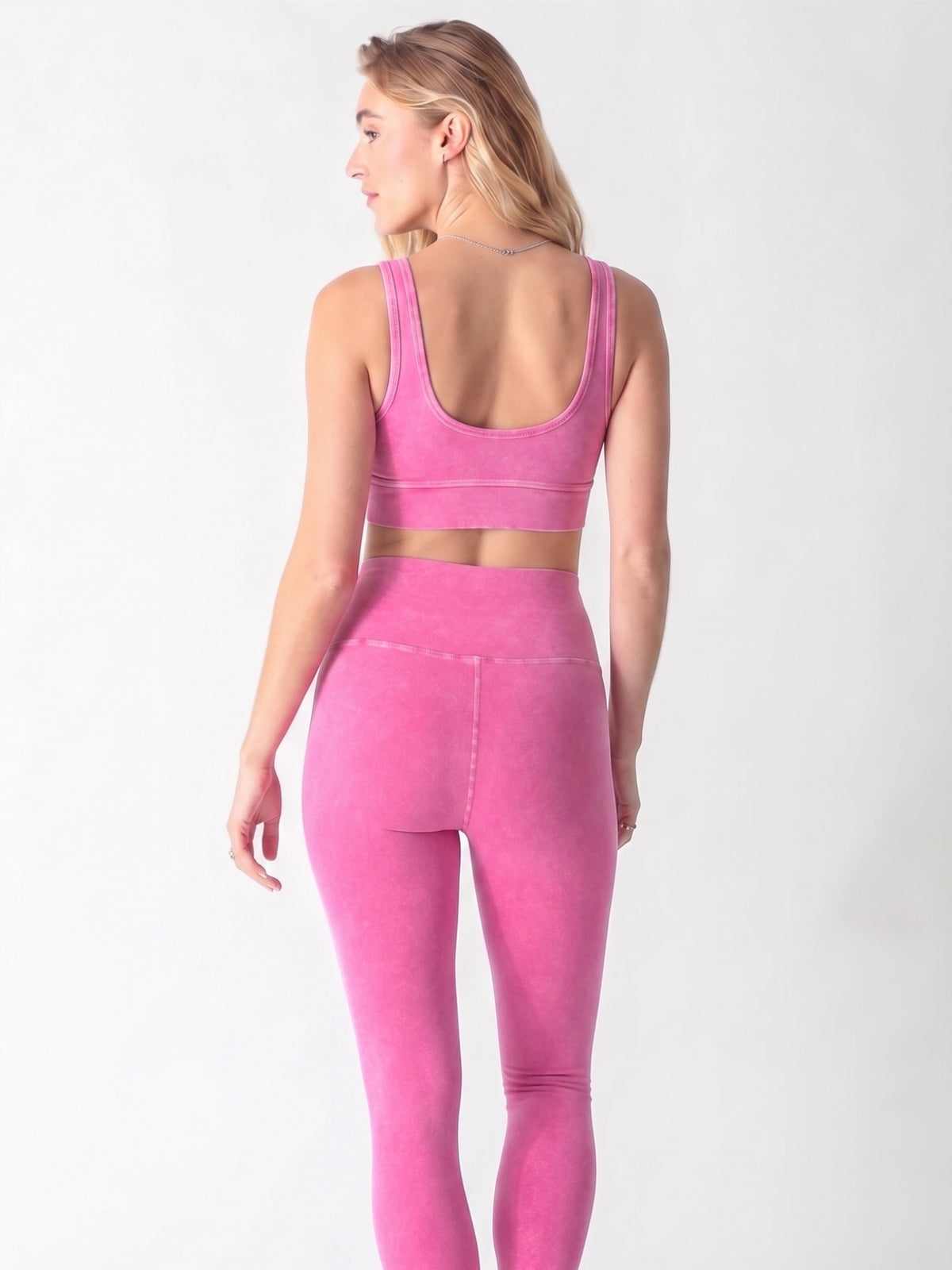 Mineral-washed hot pink sports bra featuring a scoop neck, wide shoulder straps, and a thick underband.