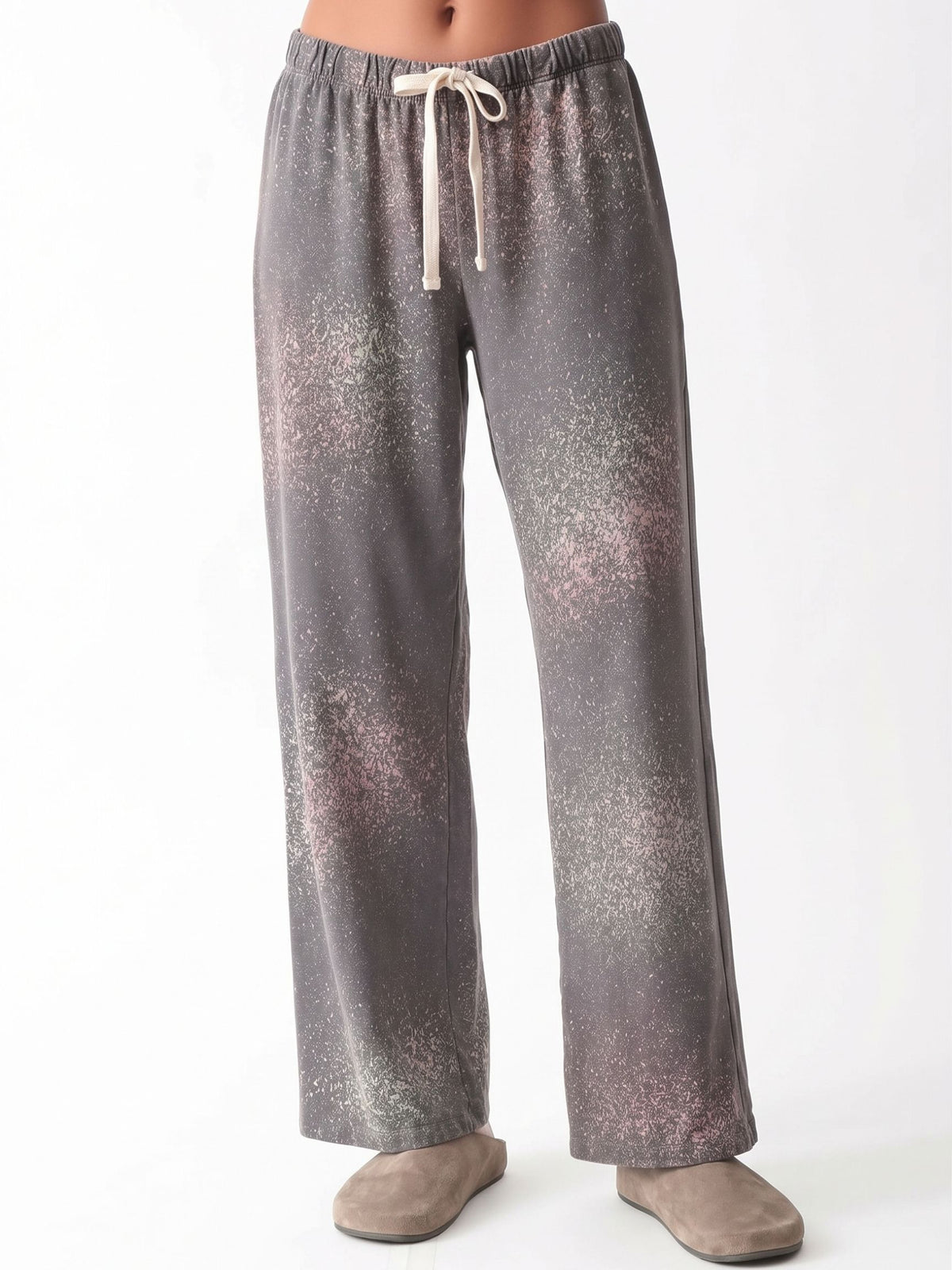 Woman wearing a charcoal gray oversized V-neck French terry sweatshirt with a pink and sage speckled dye print and matching wide-leg sweatpants by Electric & Rose