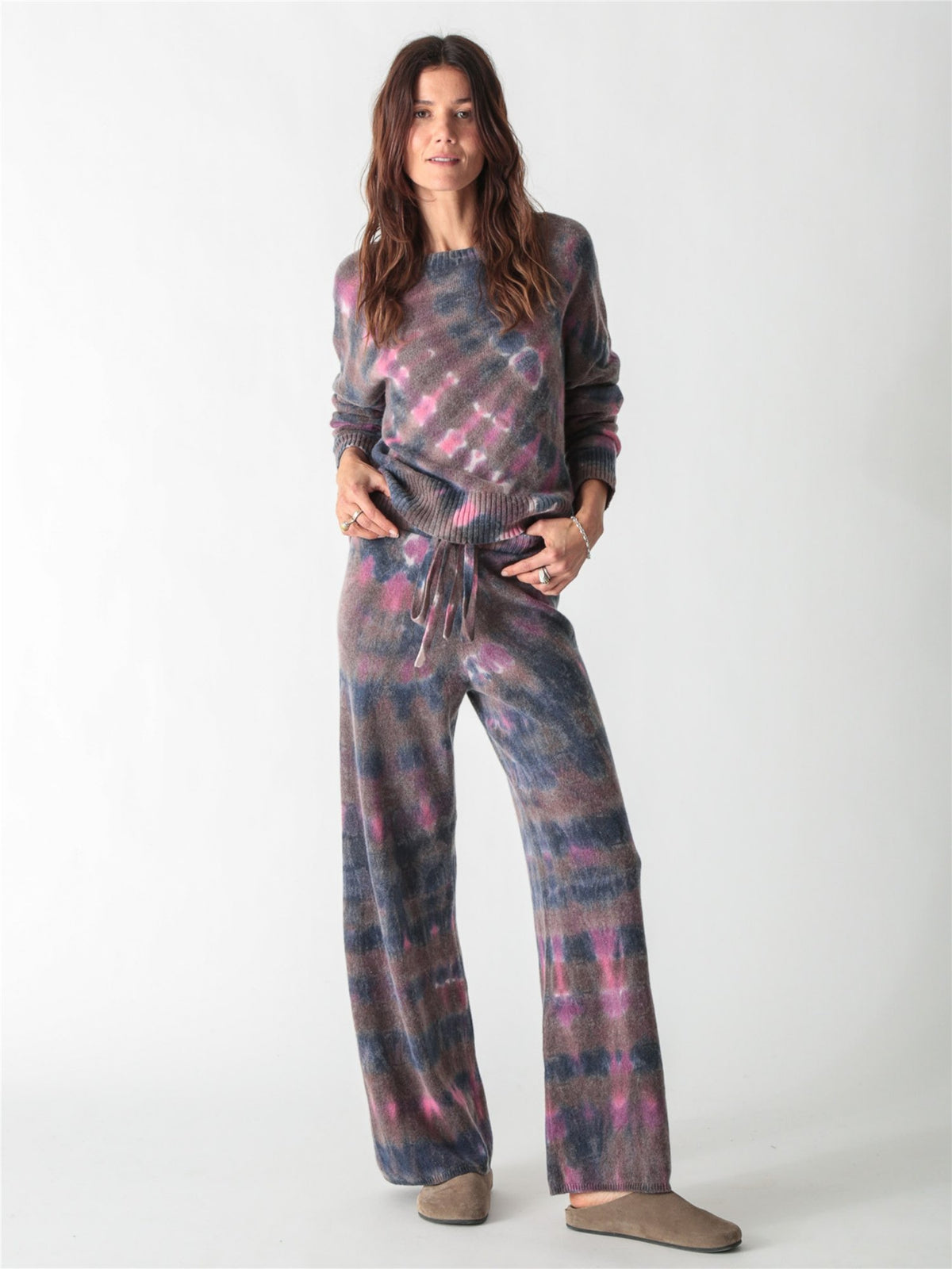 High-waisted, wide-leg knit pants with an adjustable drawstring waist, featuring a tie-dye pattern in charcoal gray, soft purple, and bright pink accents.