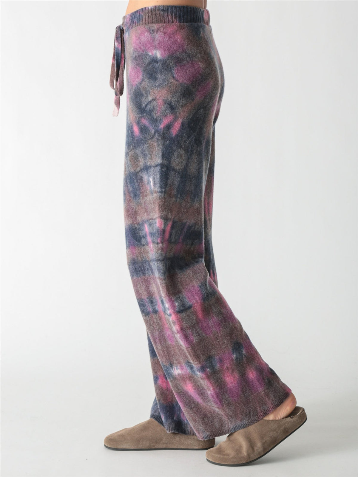 High-waisted, wide-leg knit pants with an adjustable drawstring waist, featuring a tie-dye pattern in charcoal gray, soft purple, and bright pink accents.