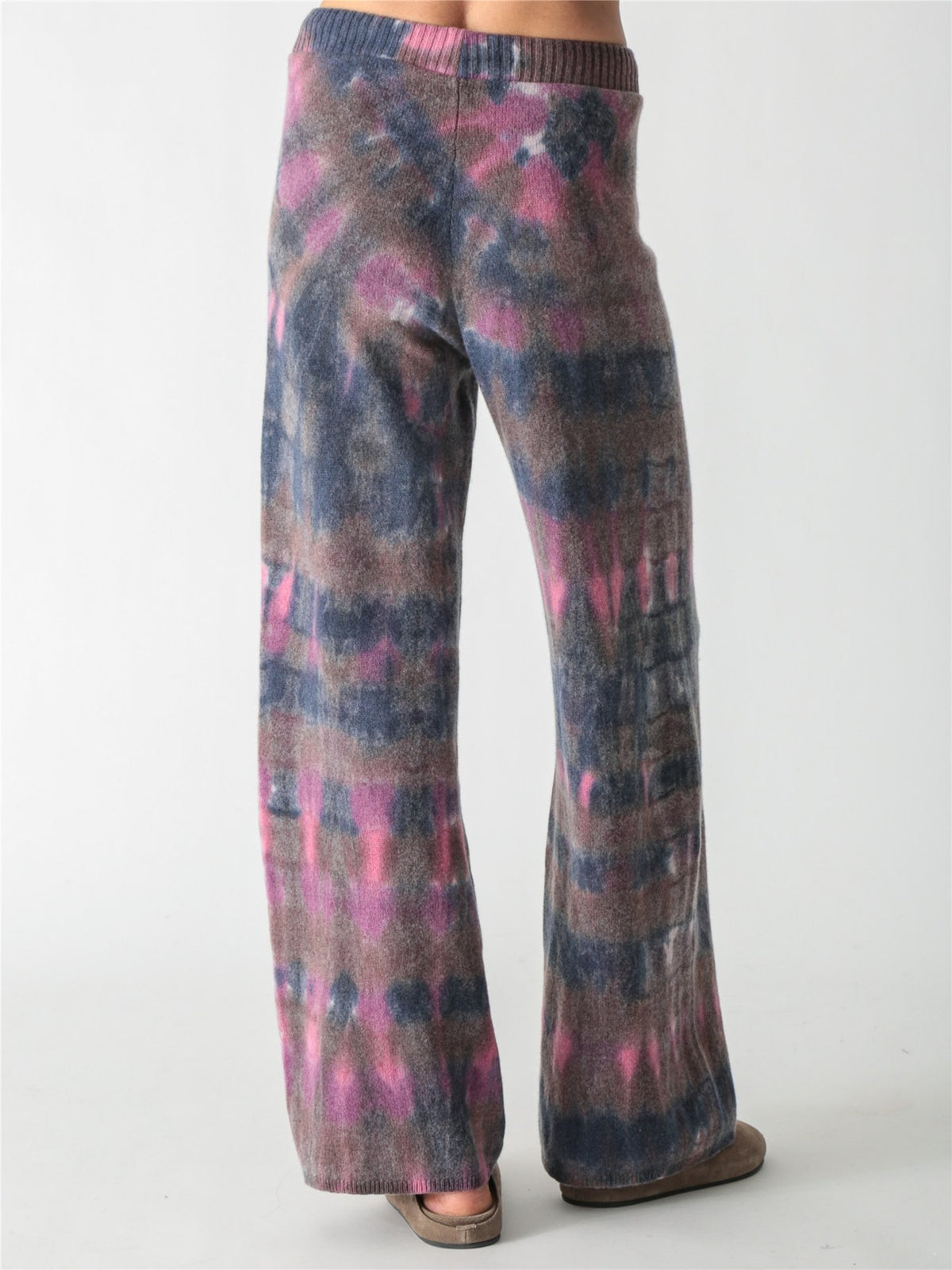 High-waisted, wide-leg knit pants with an adjustable drawstring waist, featuring a tie-dye pattern in charcoal gray, soft purple, and bright pink accents.