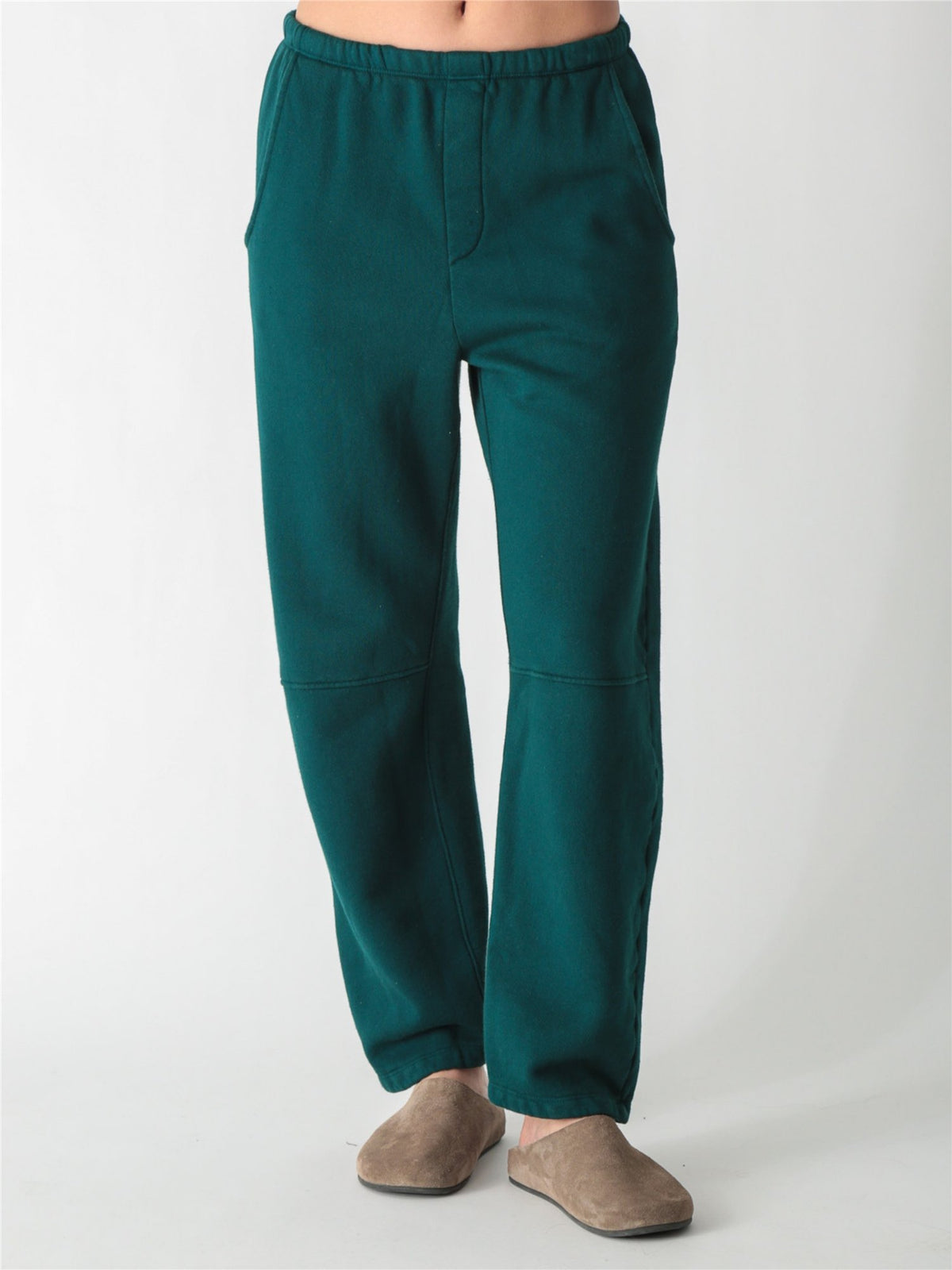Dark teal green wide-leg fleece sweatpants featuring an elastic waistband, side pockets, and knee panel seam details.