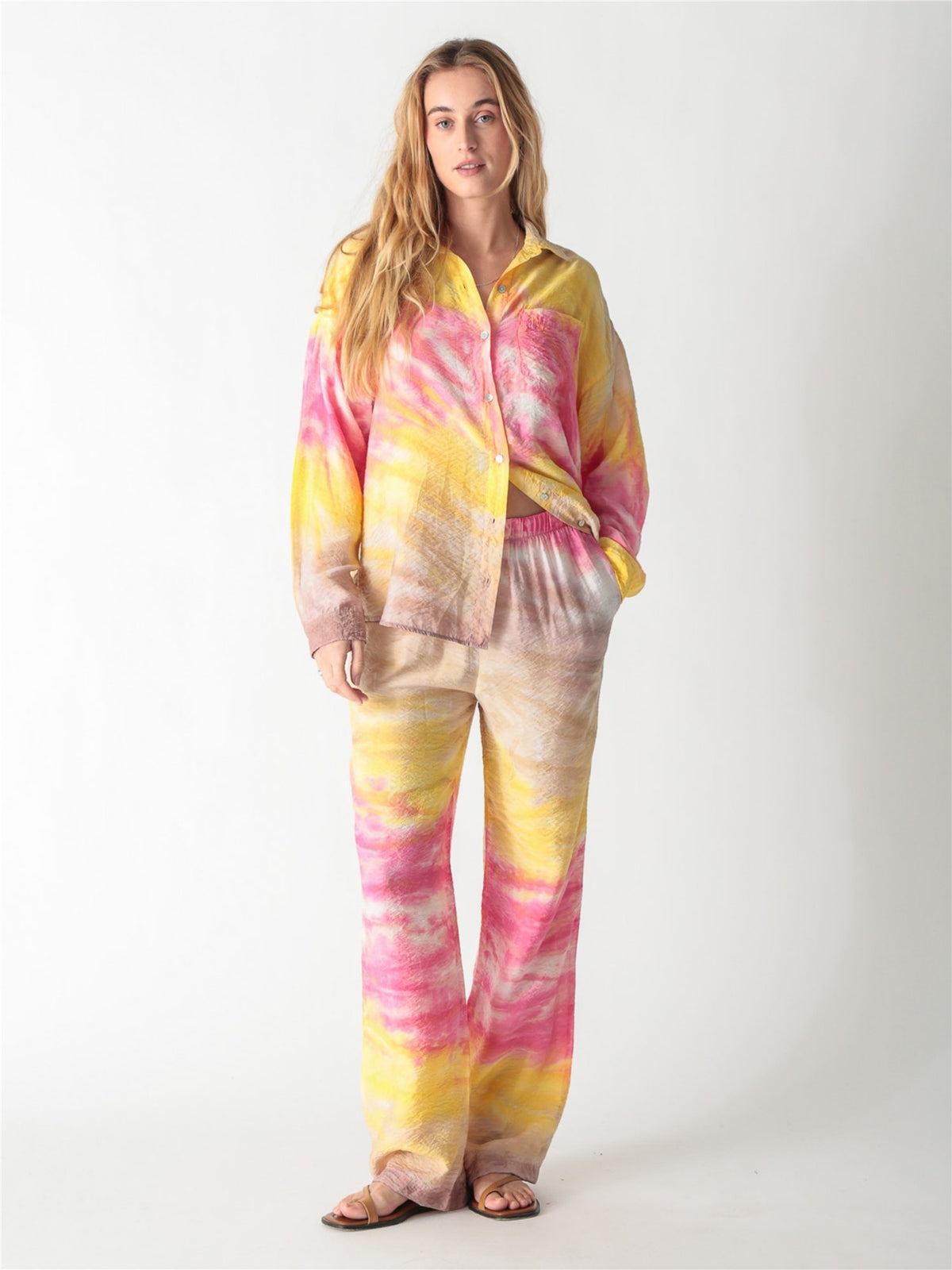 Pink and yellow tie-dye relaxed wide-leg trousers with an elastic waistband.