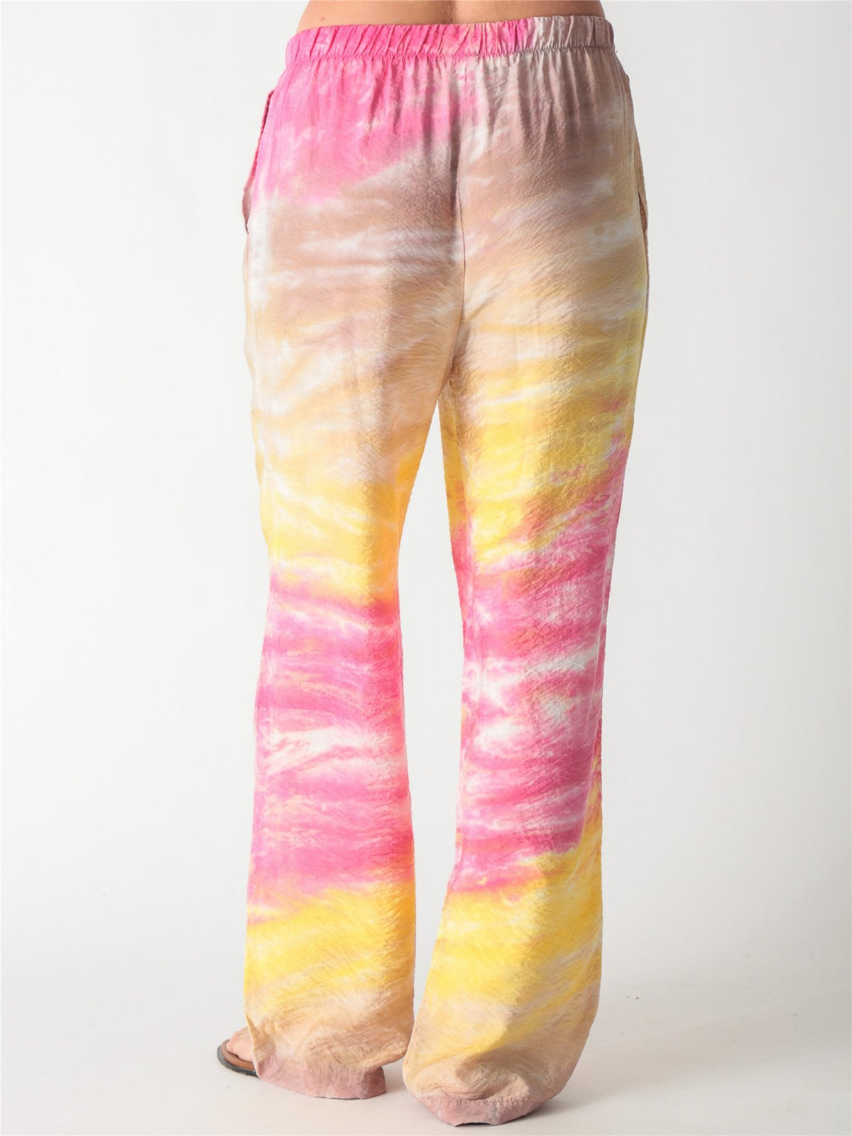 Pink and yellow tie-dye relaxed wide-leg trousers with an elastic waistband.