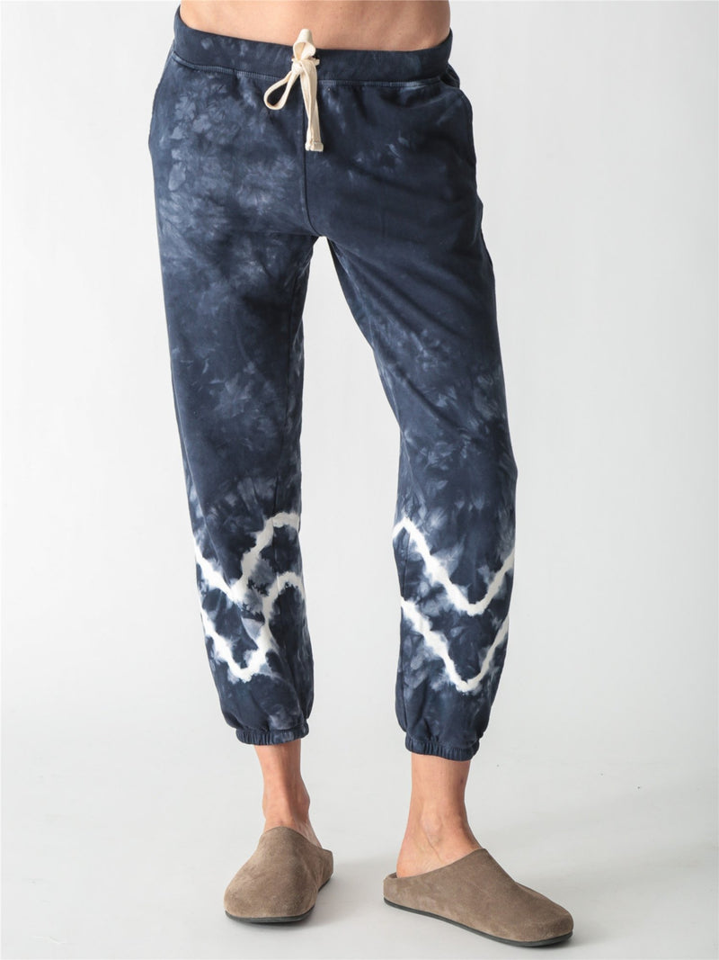 Navy blue tie-dye jogger sweatpants with a white drawstring and white tie-dye bands around the lower legs.