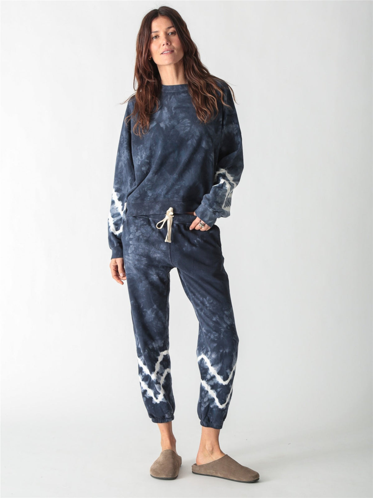 Navy blue tie-dye jogger sweatpants with a white drawstring and white tie-dye bands around the lower legs.