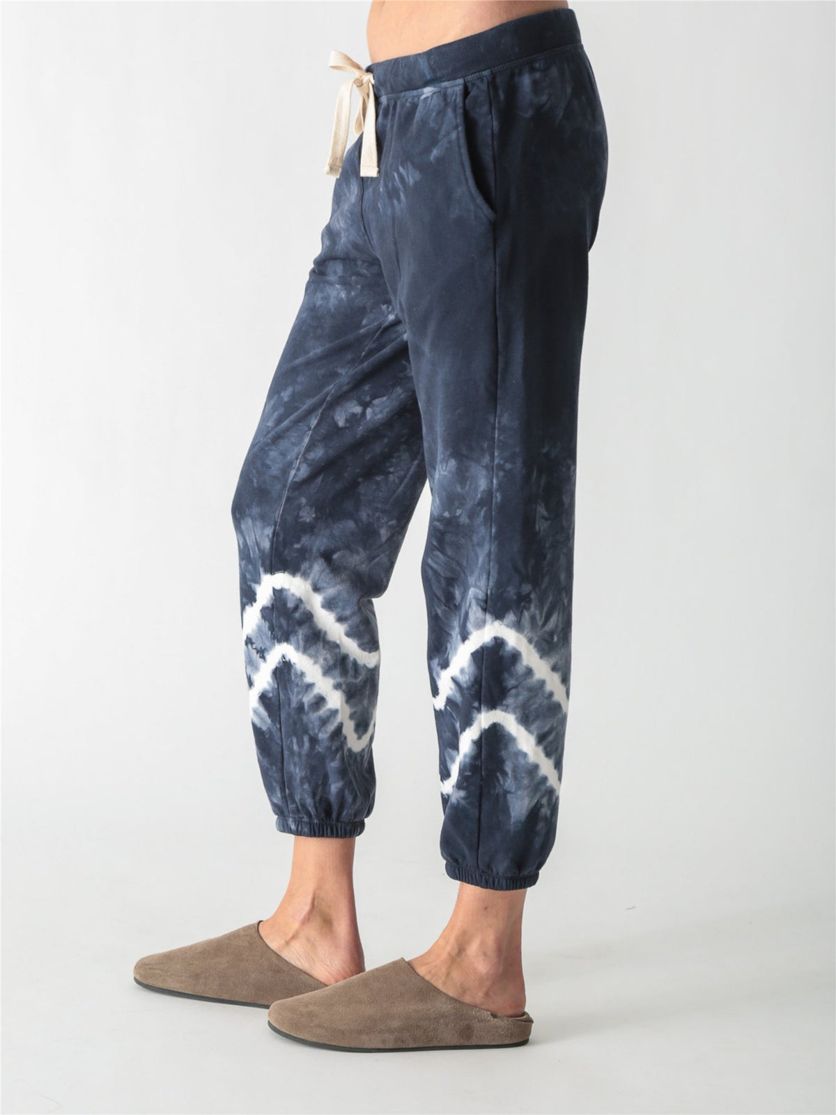 Navy blue tie-dye jogger sweatpants with a white drawstring and white tie-dye bands around the lower legs.