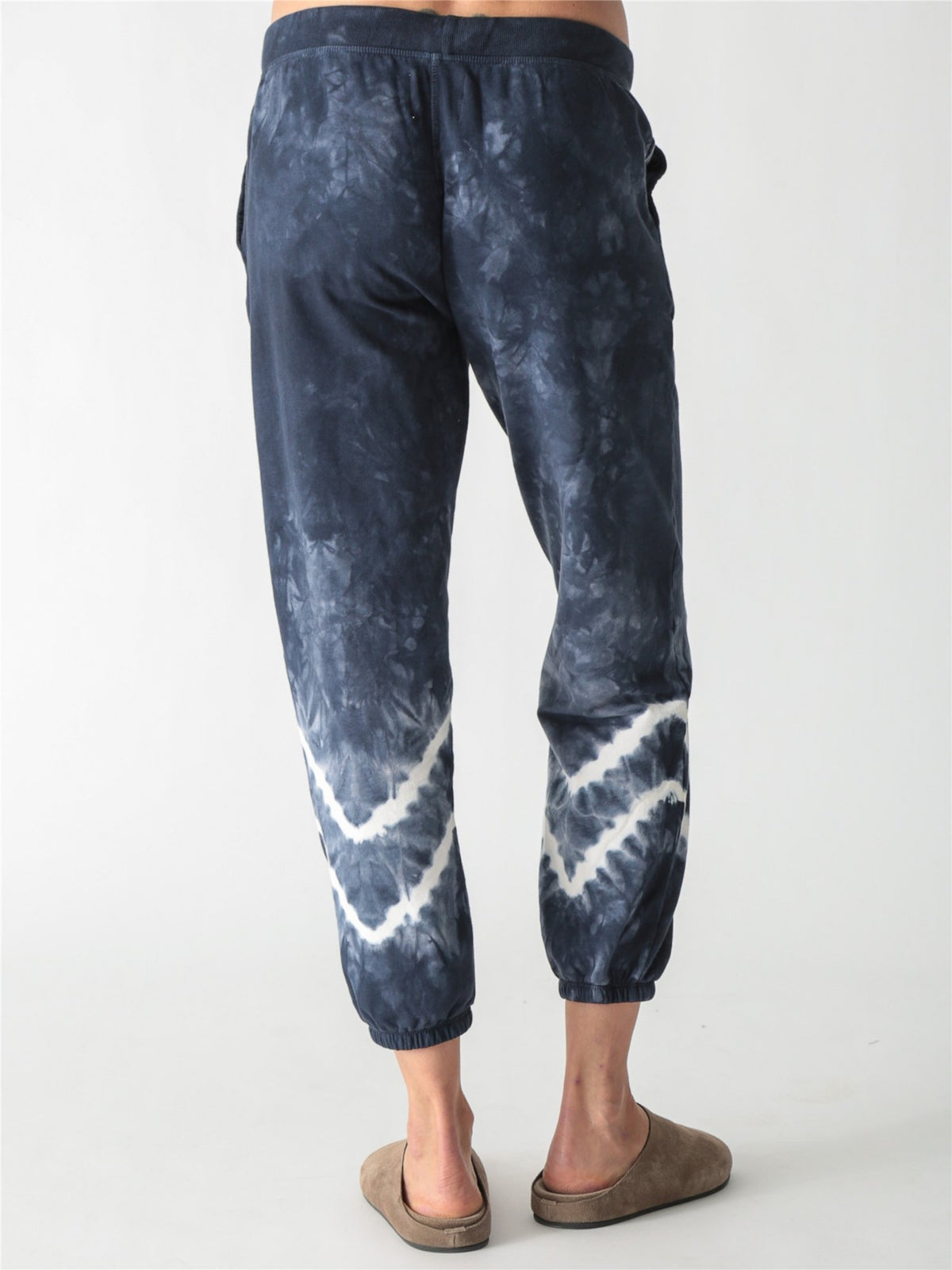 Navy blue tie-dye jogger sweatpants with a white drawstring and white tie-dye bands around the lower legs.