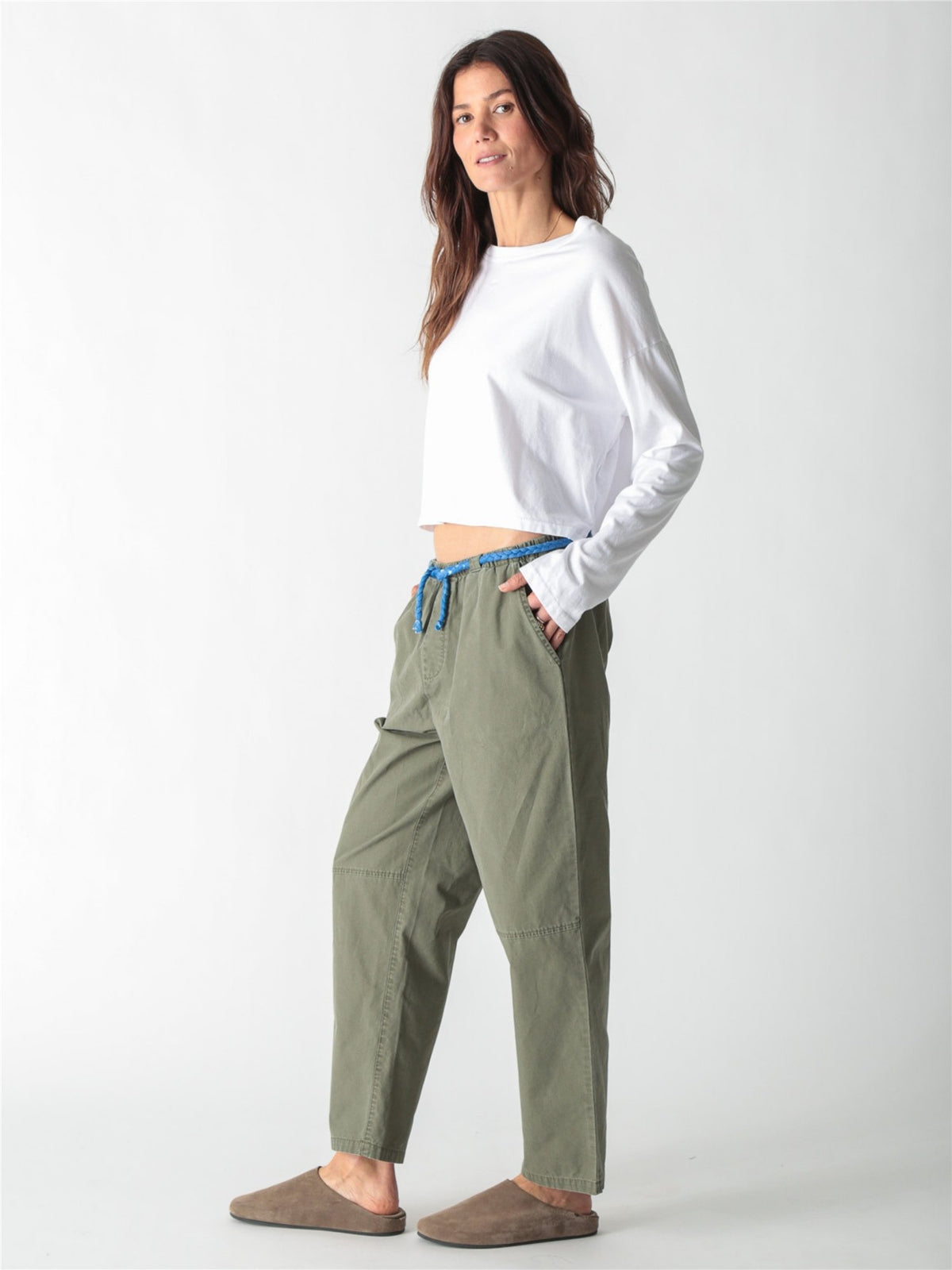 Olive green relaxed straight-leg pants with a bright blue rope drawstring waist and horizontal knee seam details.