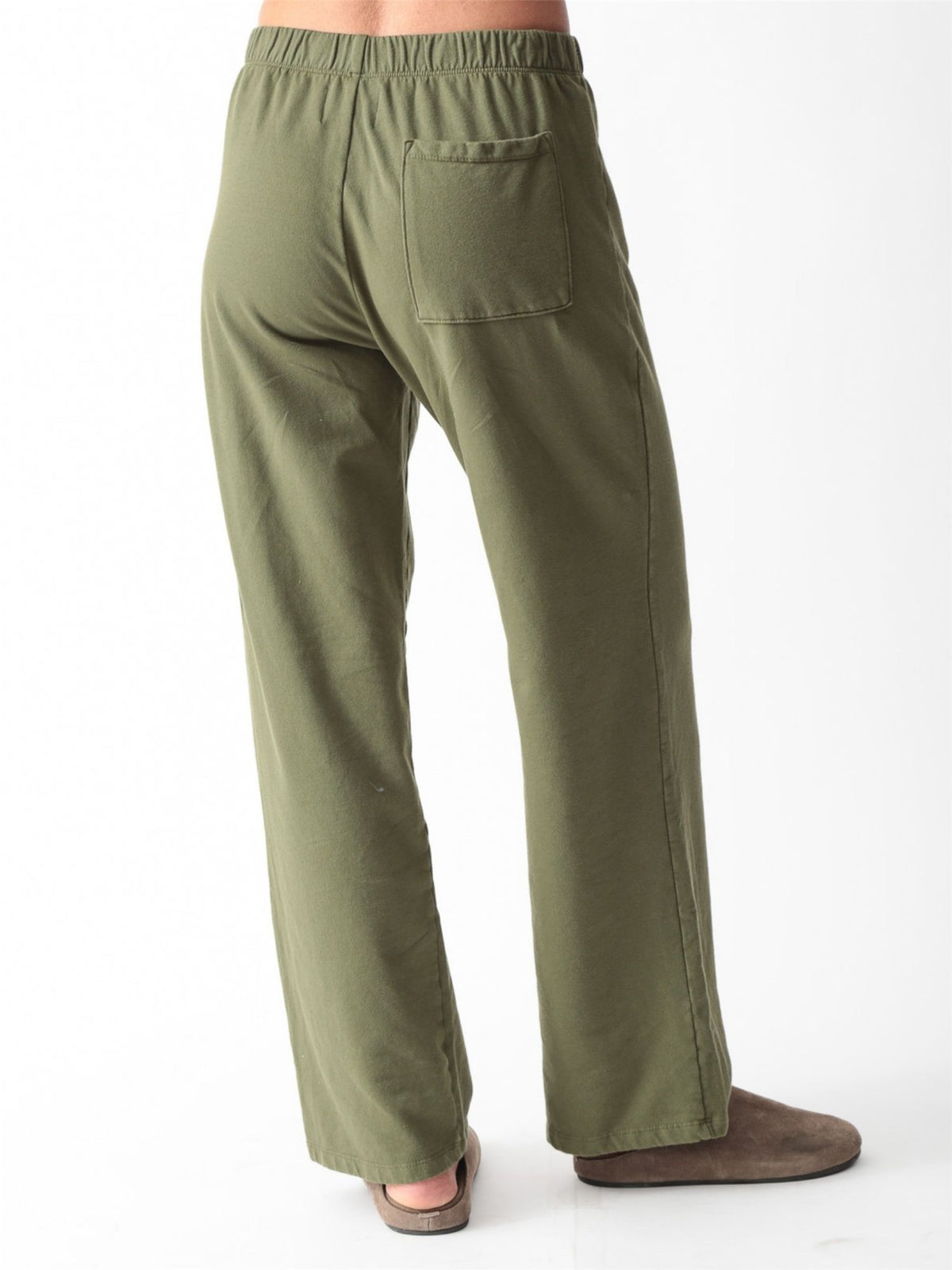 Woman wearing an olive green oversized V-neck sweatshirt with balloon sleeves and matching wide-leg sweatpants by Electric & Rose