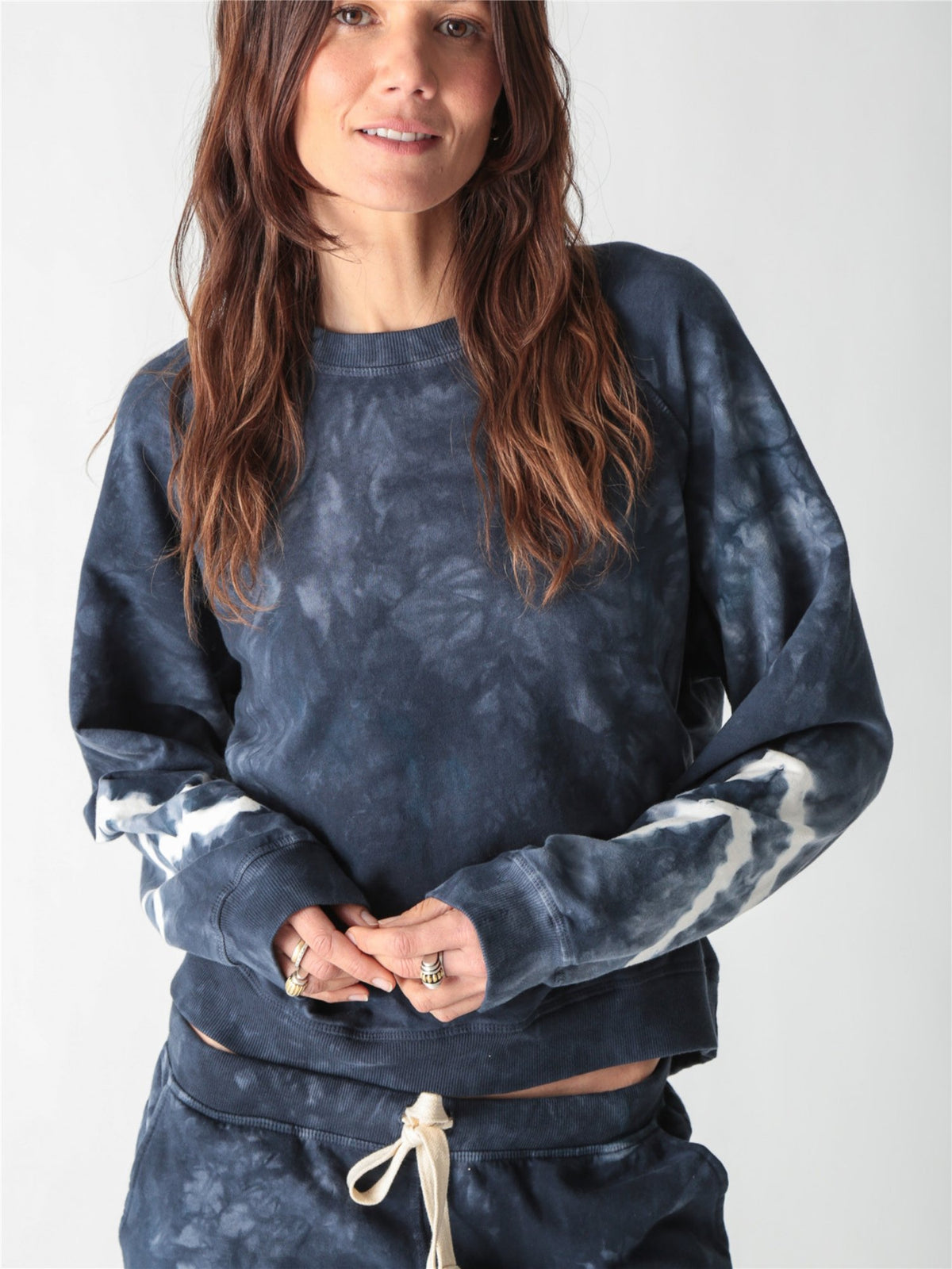 Navy blue tie-dye crewneck sweatshirt with long sleeves featuring white contrast tie-dye bands.