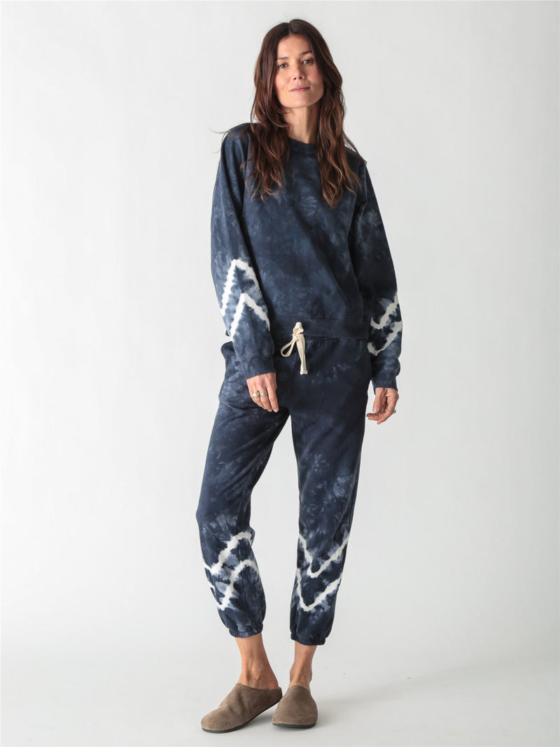 Navy blue tie-dye crewneck sweatshirt with long sleeves featuring white contrast tie-dye bands.