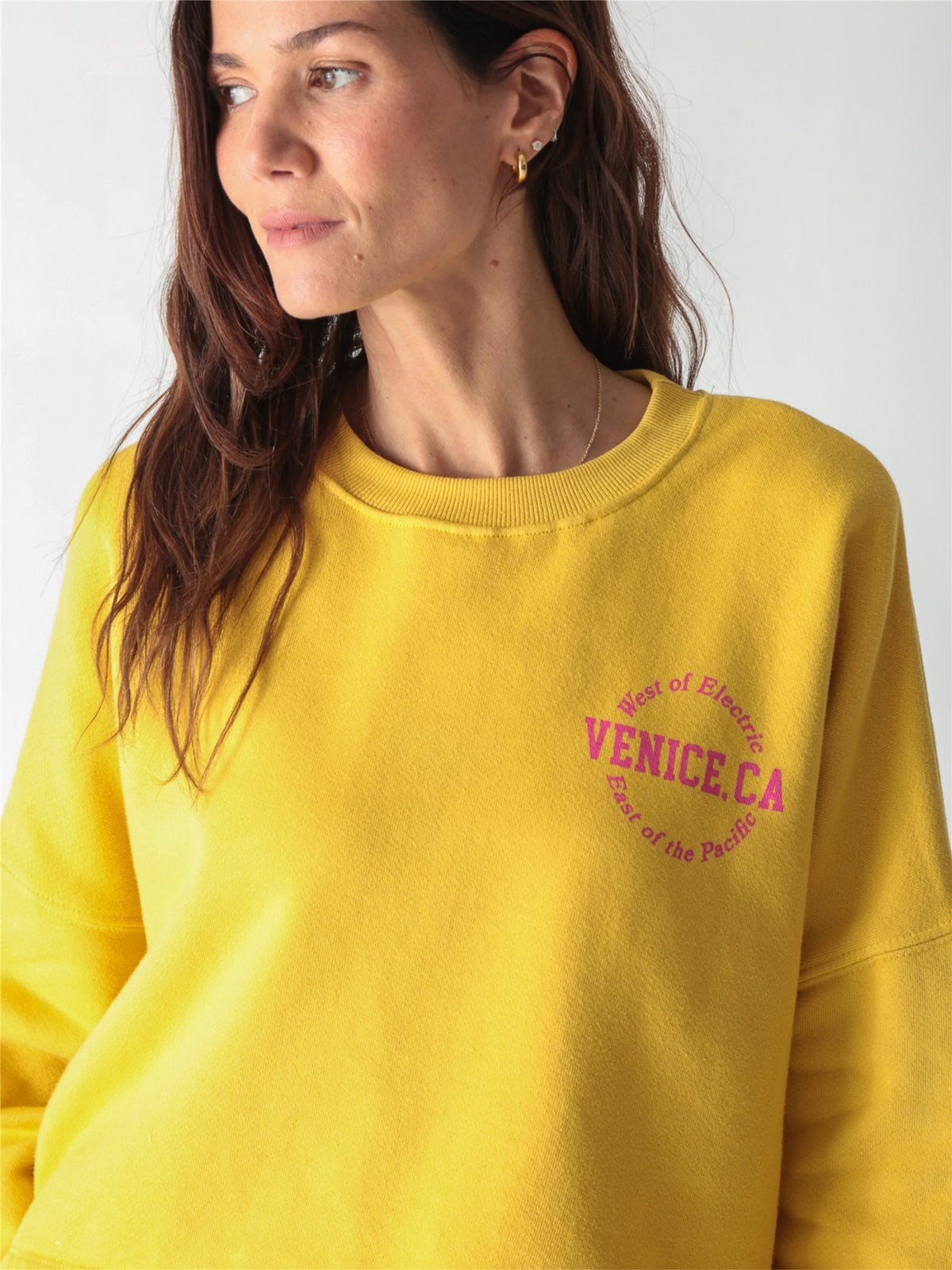 A yellow oversized cropped crewneck sweatshirt with dropped shoulders and ribbed cuffs.