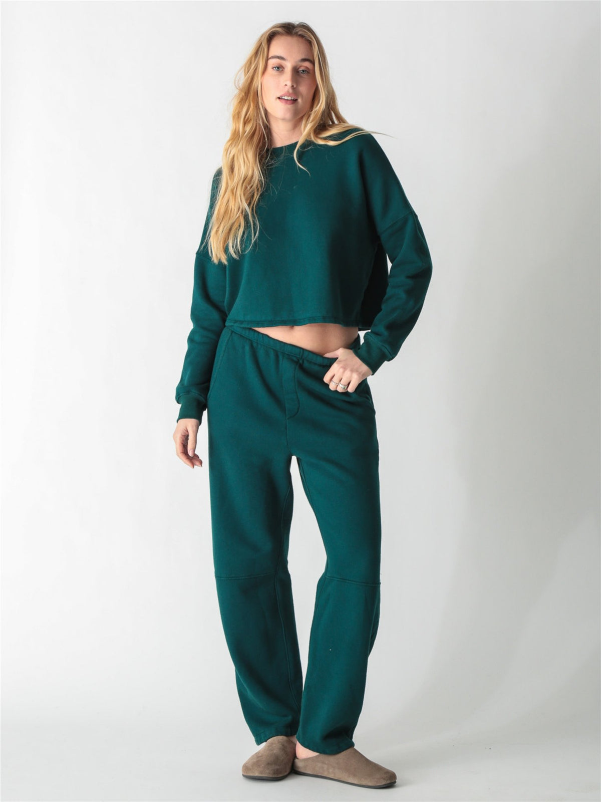 A dark teal green oversized cropped crewneck sweatshirt with dropped shoulders and ribbed cuffs.
