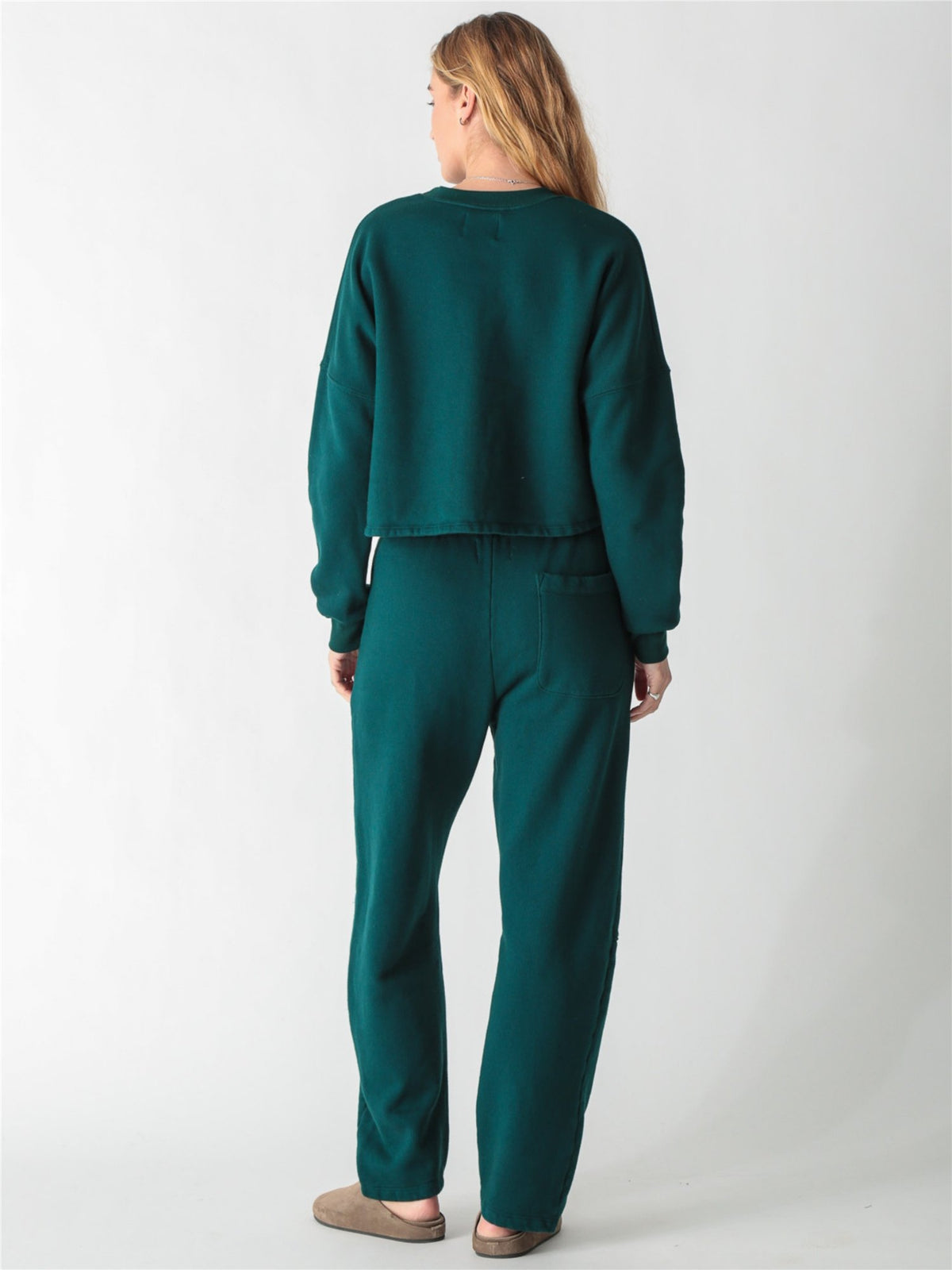 A dark teal green oversized cropped crewneck sweatshirt with dropped shoulders and ribbed cuffs.