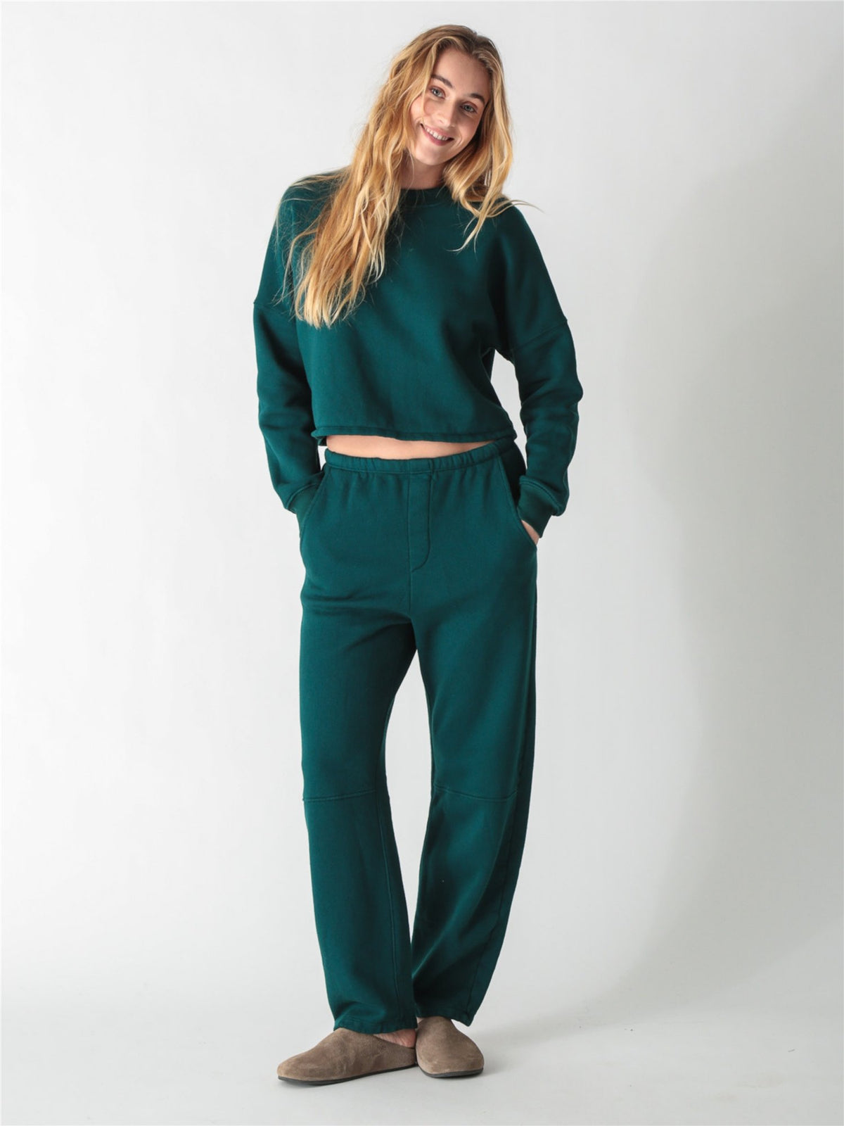 A dark teal green oversized cropped crewneck sweatshirt with dropped shoulders and ribbed cuffs.