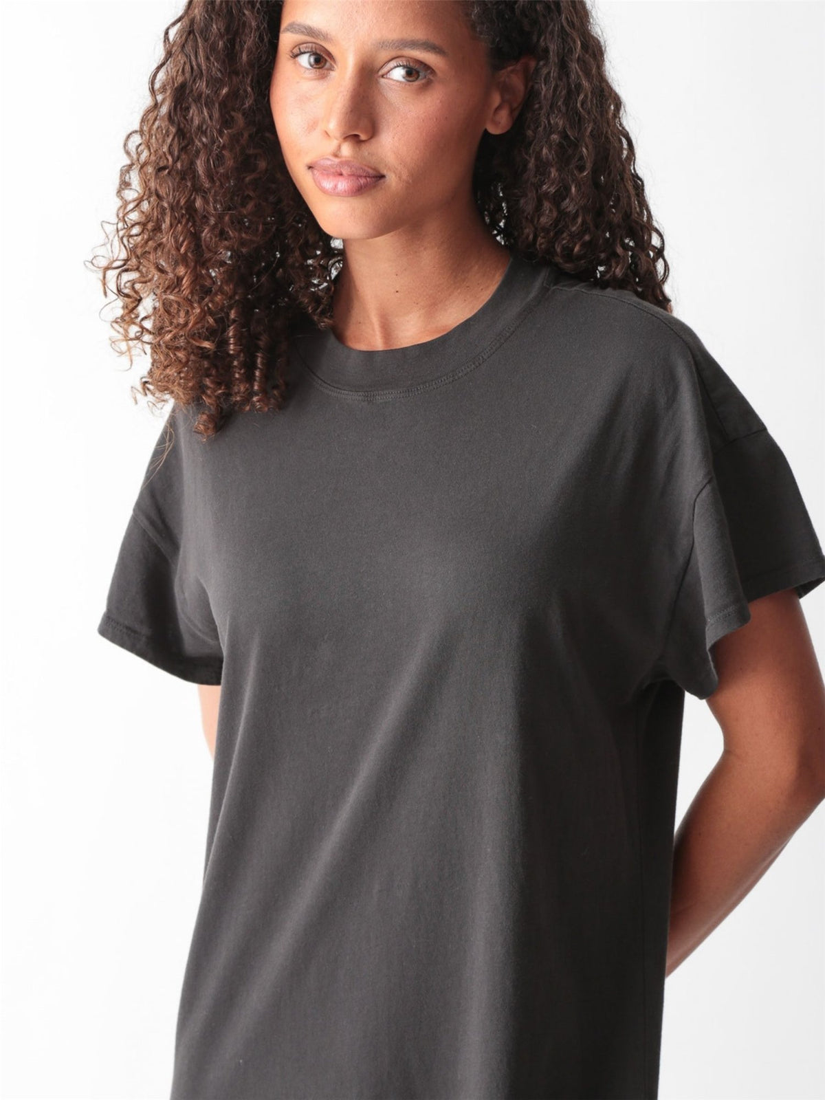 Woman wearing a grey cotton jersey maxi T-shirt dress with short cuffed sleeves, crew neck, and side slit by Electric & Rose