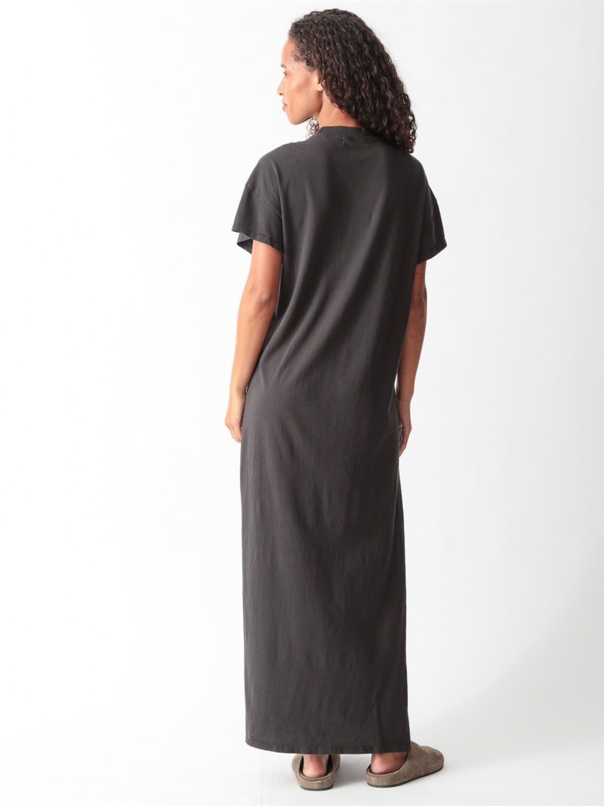 Woman wearing a grey cotton jersey maxi T-shirt dress with short cuffed sleeves, crew neck, and side slit by Electric & Rose