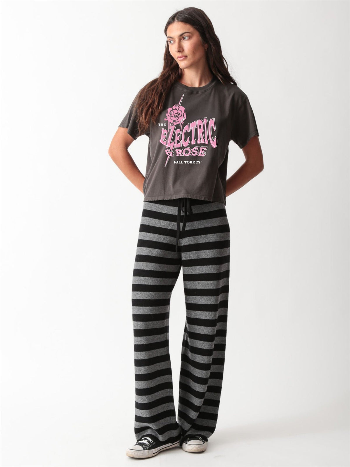 Close-up of a vintage-wash charcoal graphic tee with a pink "The Electric & Rose Fall Tour 77" band-style print featuring a rose and lightning bolt