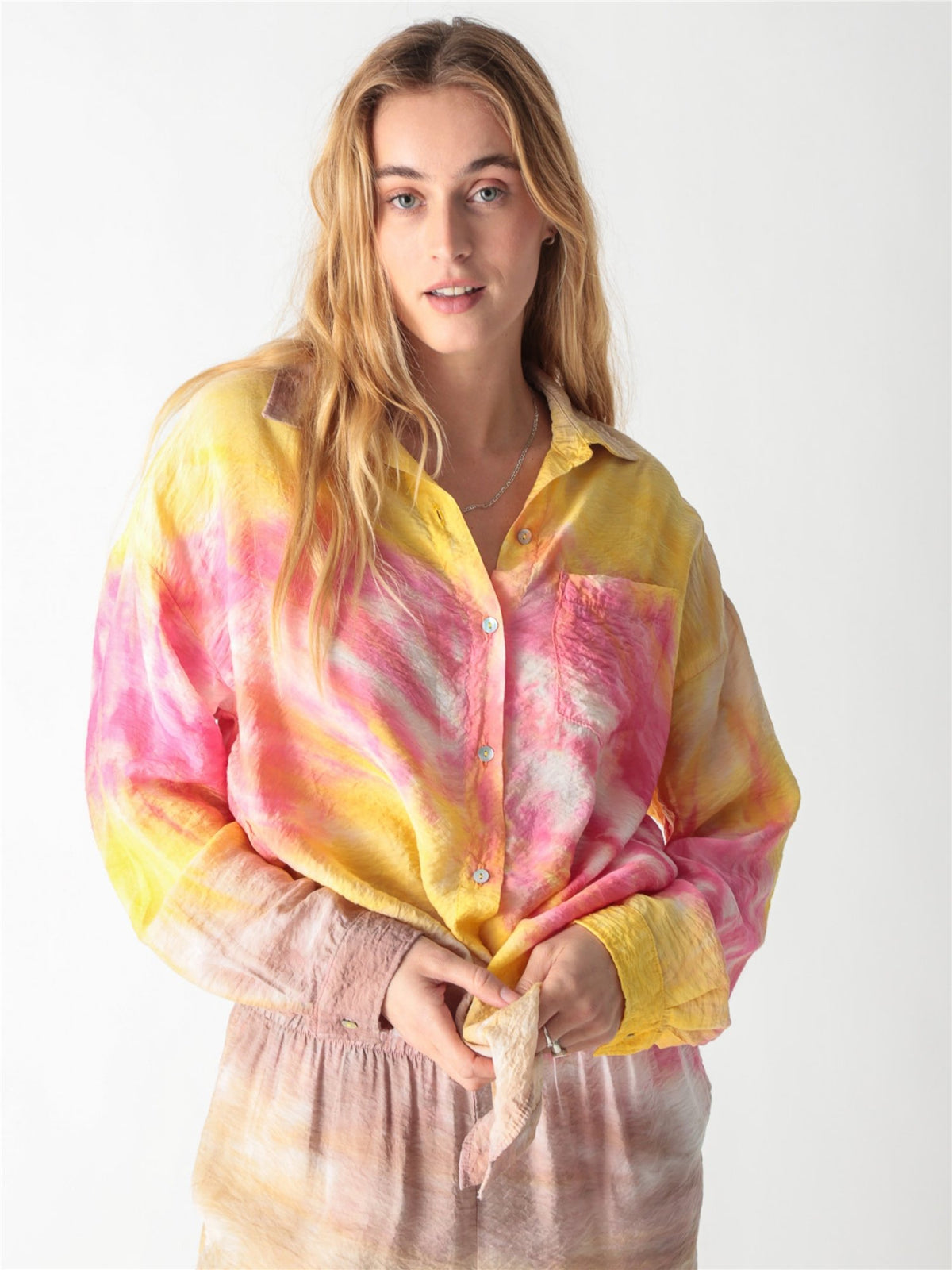 A pink and yellow tie-dye long-sleeve button-down shirt with a classic collar and single chest pocket.