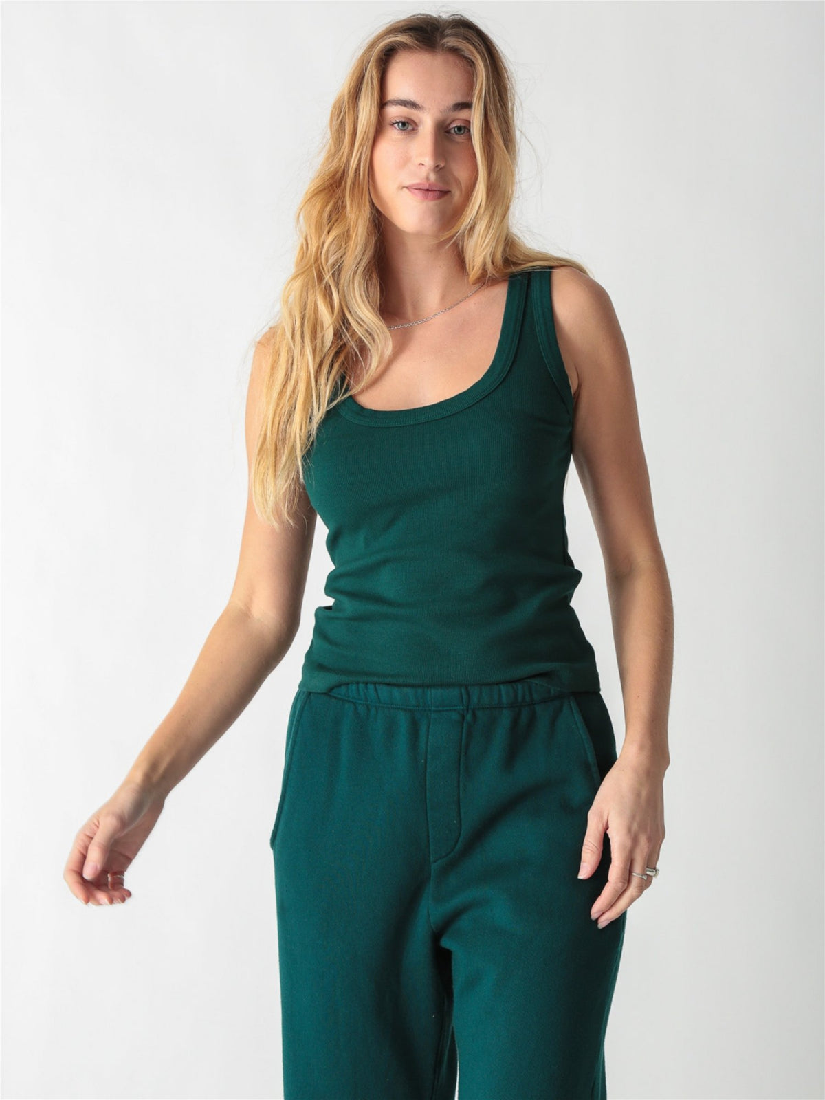 Pine green ribbed tank top with a scoop neckline and thick straps.