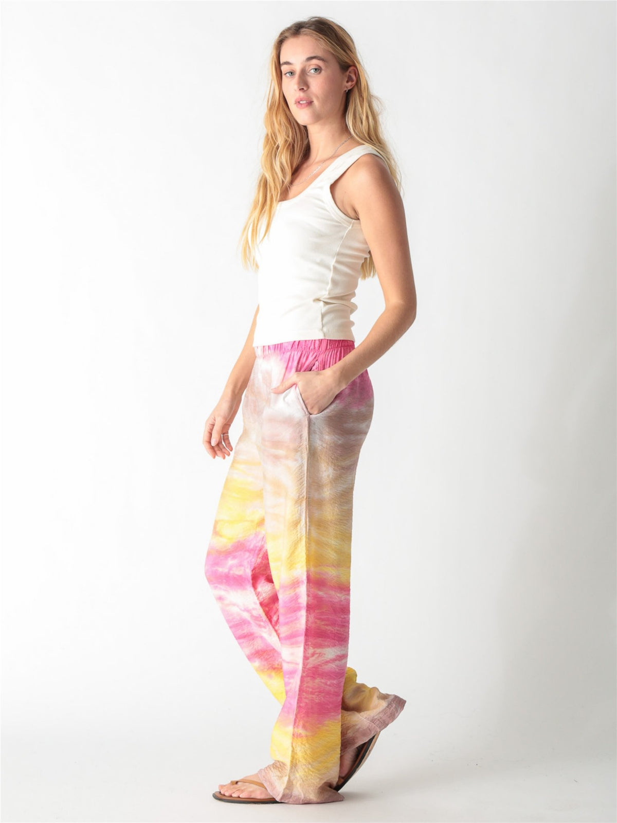 Off-white ribbed tank top with a scoop neckline and thick straps.